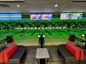 Strikers Bowling lanes with neon lighting, digital scoreboards, and exclusive Bowling Specials & Deals for walk-in packages and group offers in Sunrise, FL.