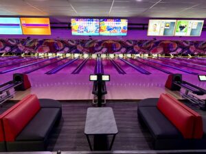 Modern bowling lanes with neon lighting, stylish seating, and exclusive Bowling Specials & Deals at Strikers Bowling in Sunrise, FL.